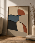 Layered Stillness | Printable Abstract Wall Art | Morphē Studio — framed earthy abstract print in oak frame leaning on wall beside dried grass vase and Kinfolk books