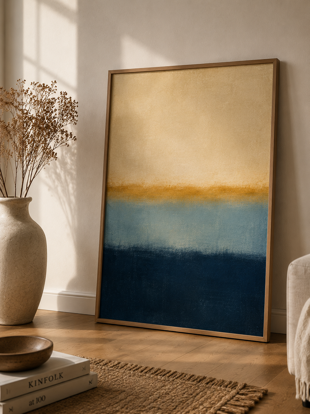 Silent Horizon | Printable Abstract Wall Art | Morphē Studio — large framed colour field abstract print leaning on floor beside ceramic vase with dried flowers and Kinfolk books in warm living room