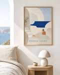Marble Light | Printable Abstract Wall Art | Morphē Studio — framed Greek island abstract print in oak frame above bedside table with white dome lamp beside Aegean sea view window